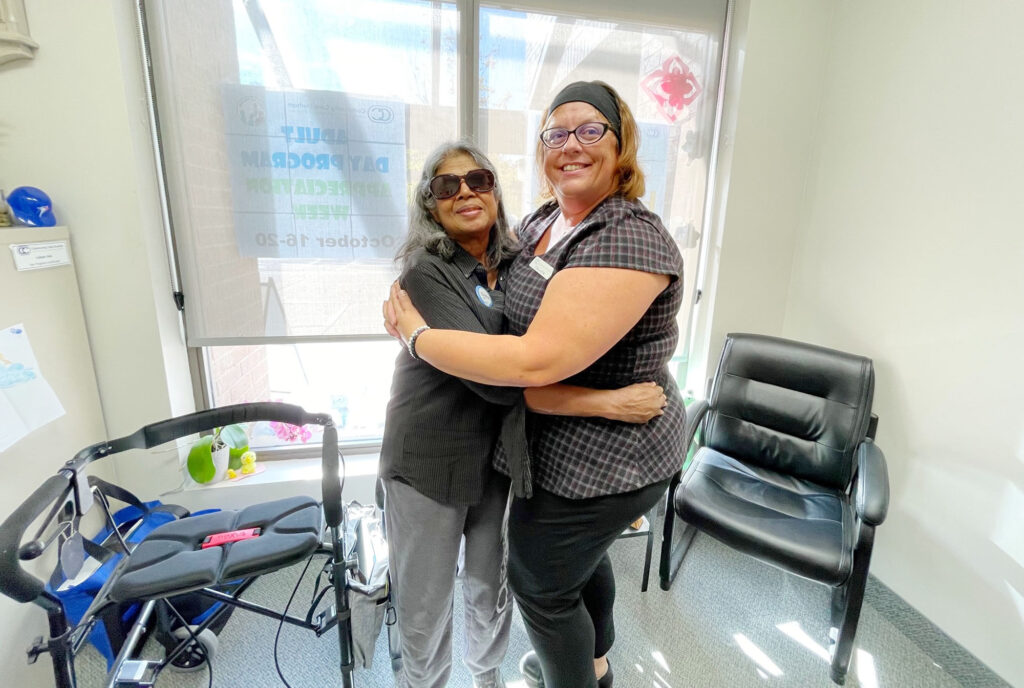 Chitra Pregasem gives Day Program Coordinator Colleen Paris a big hug. Chitra attends the ADP every Wednesday and loves the program.